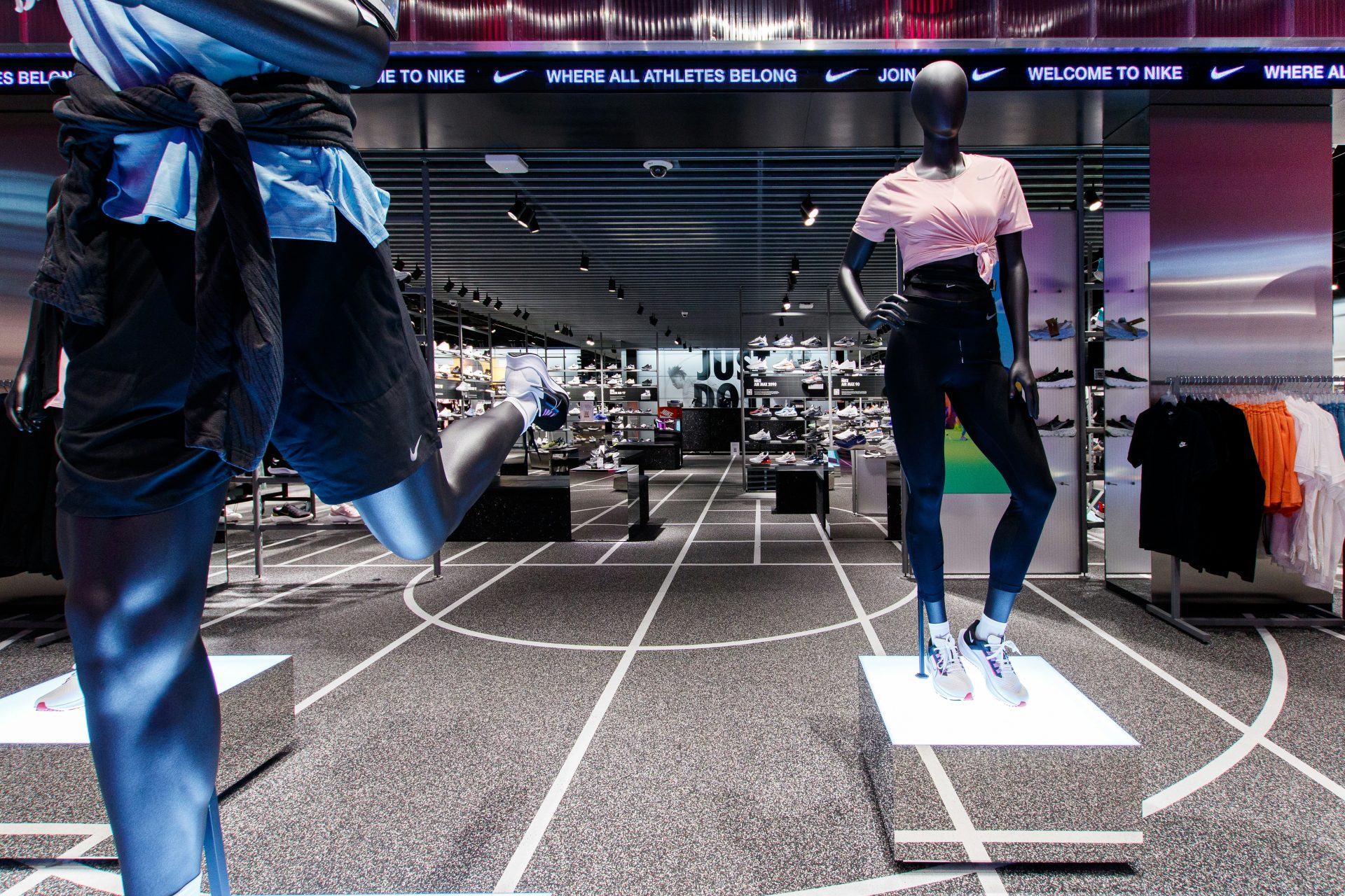 two mannequins dressed in sports clothing in a store